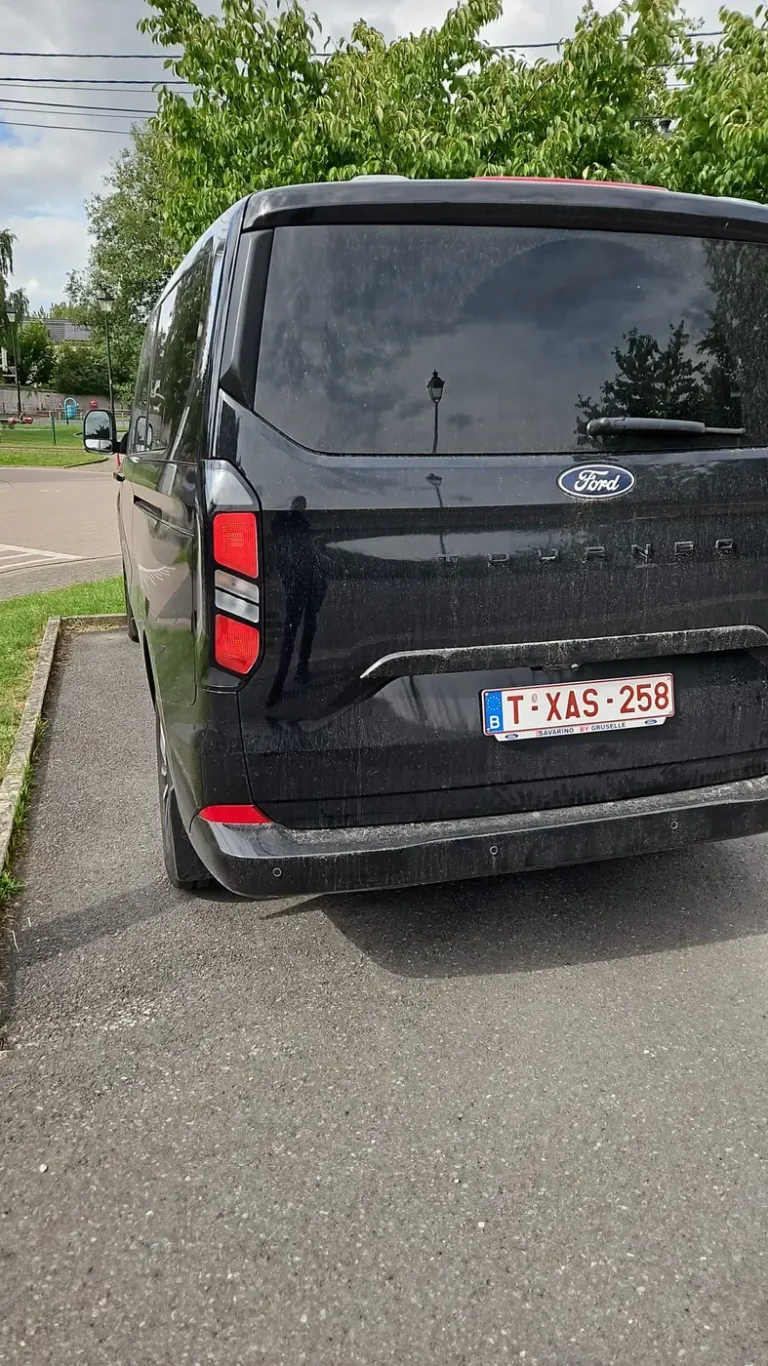 Rear of a black Ford Tourneo taxi van used for airport transfers