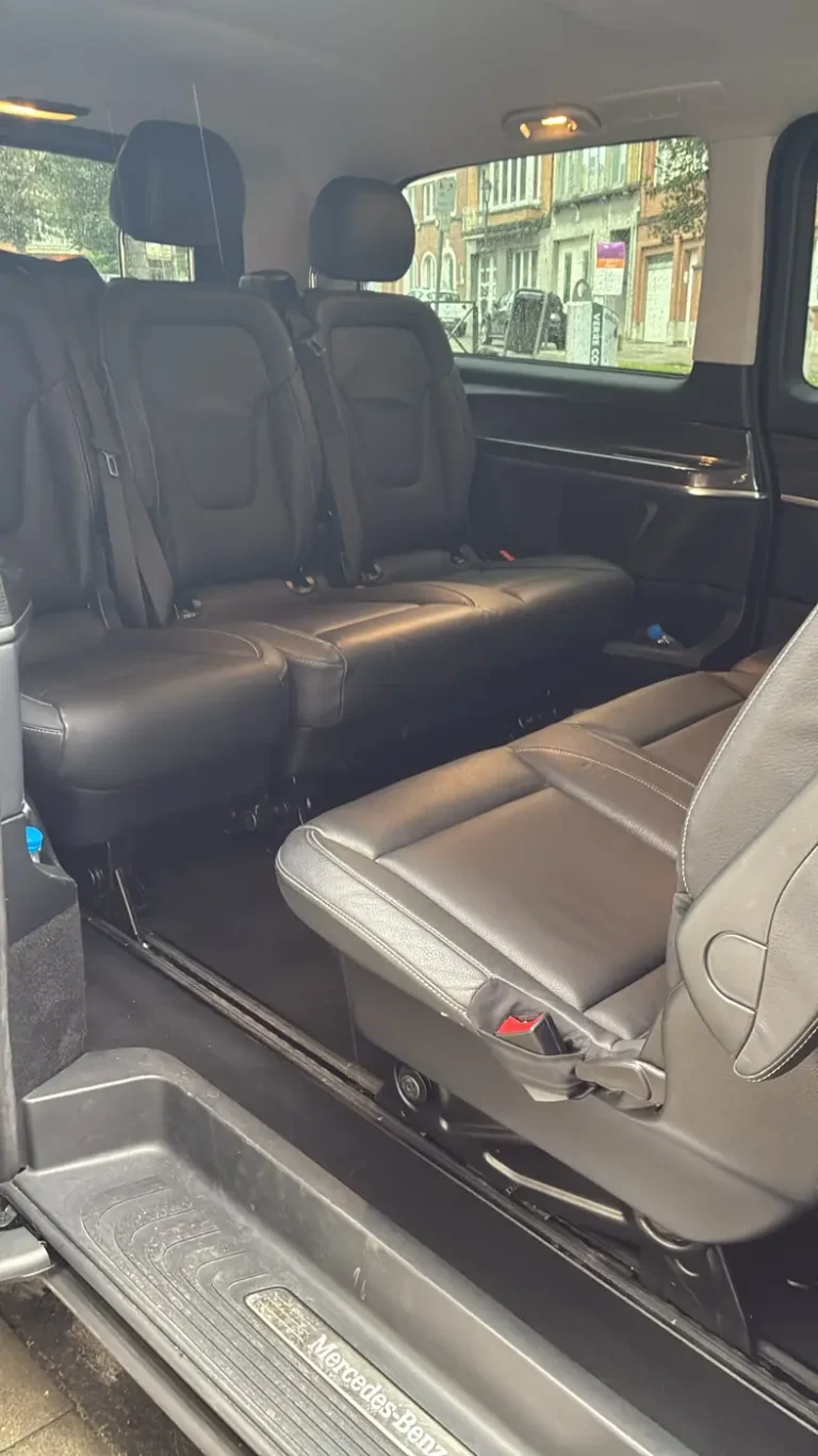 Interior of a Mercedes V-Class taxi van with black leather passenger seats