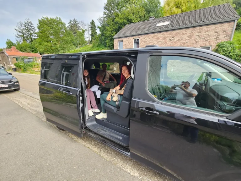 Passengers on board a taxi van for their airport transfer