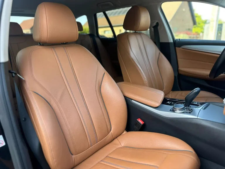 Cognac leather front seats of a car with private driver