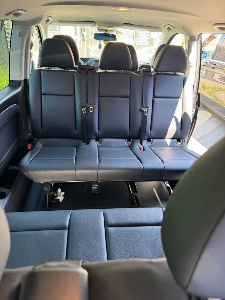 Three-seat rear bench of a taxi van with seat belts